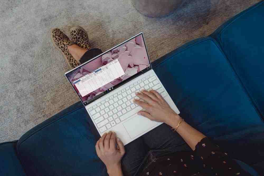 person using white laptop computer